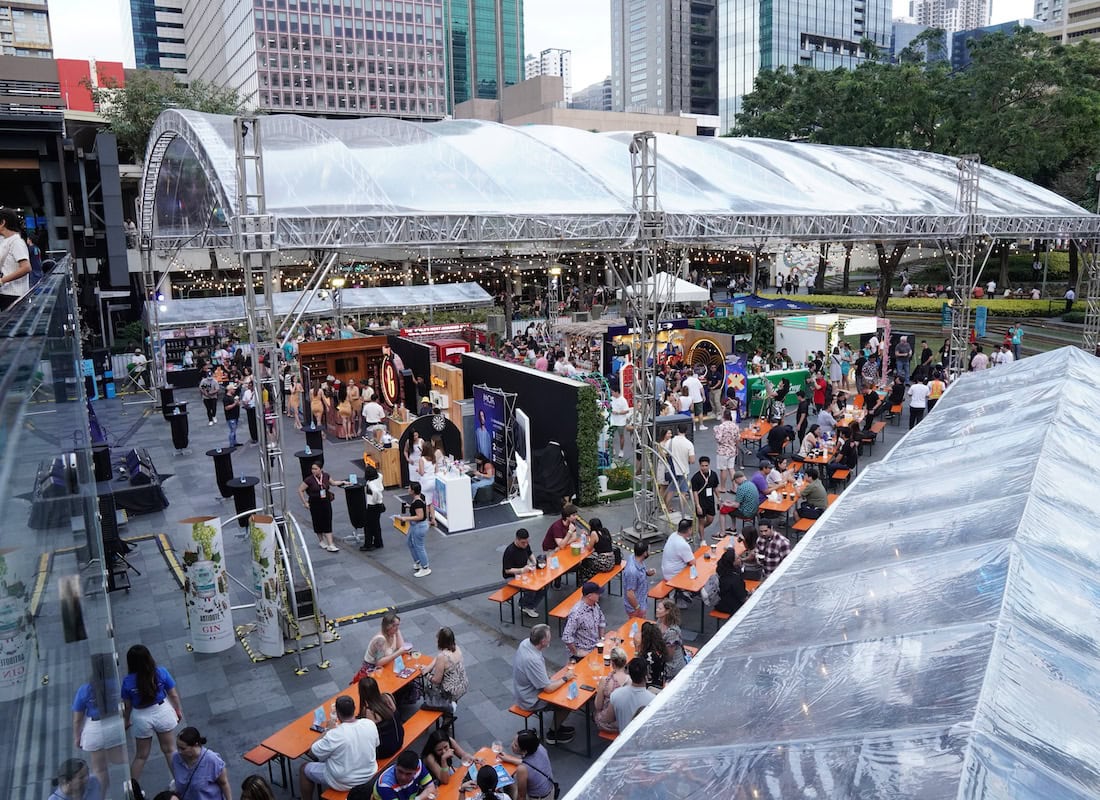 Premium gin being poured into a glass with citrus garnish